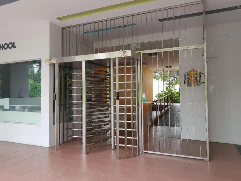 A full height double turnstile installed at the entrance of a school.